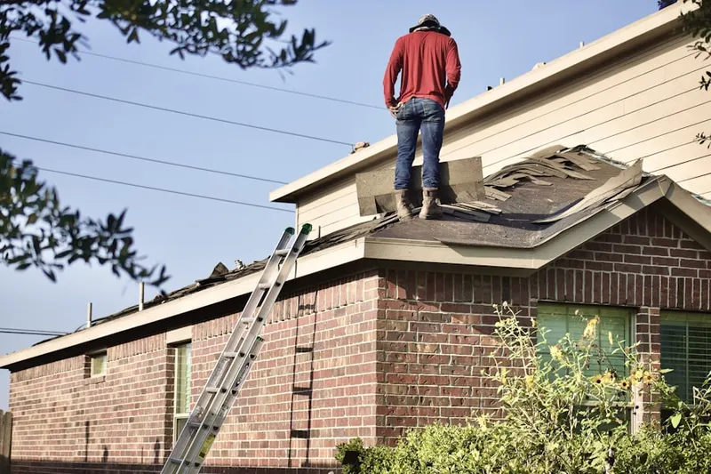 Professional roofer working on a residential roof in Oak Ridge Village